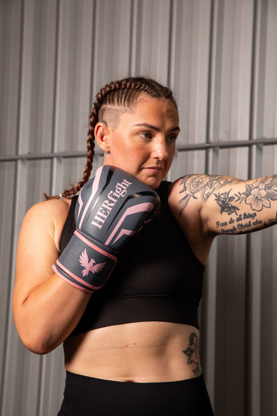 Woman wearing women’s boxing gloves in a boxing gym