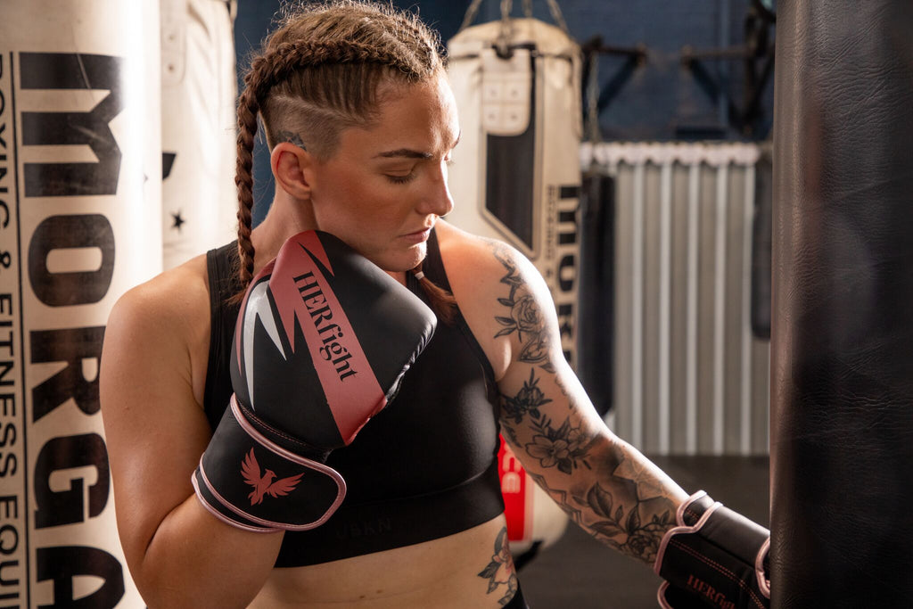 Women's boxing gloves — close-up of HERfight branding and stitching
