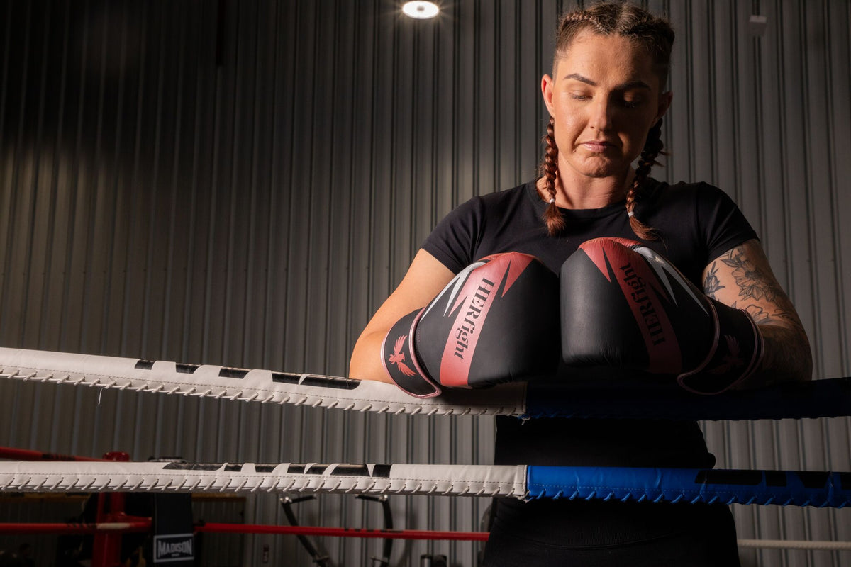 Female fit boxing gloves for women training in a boxing ring