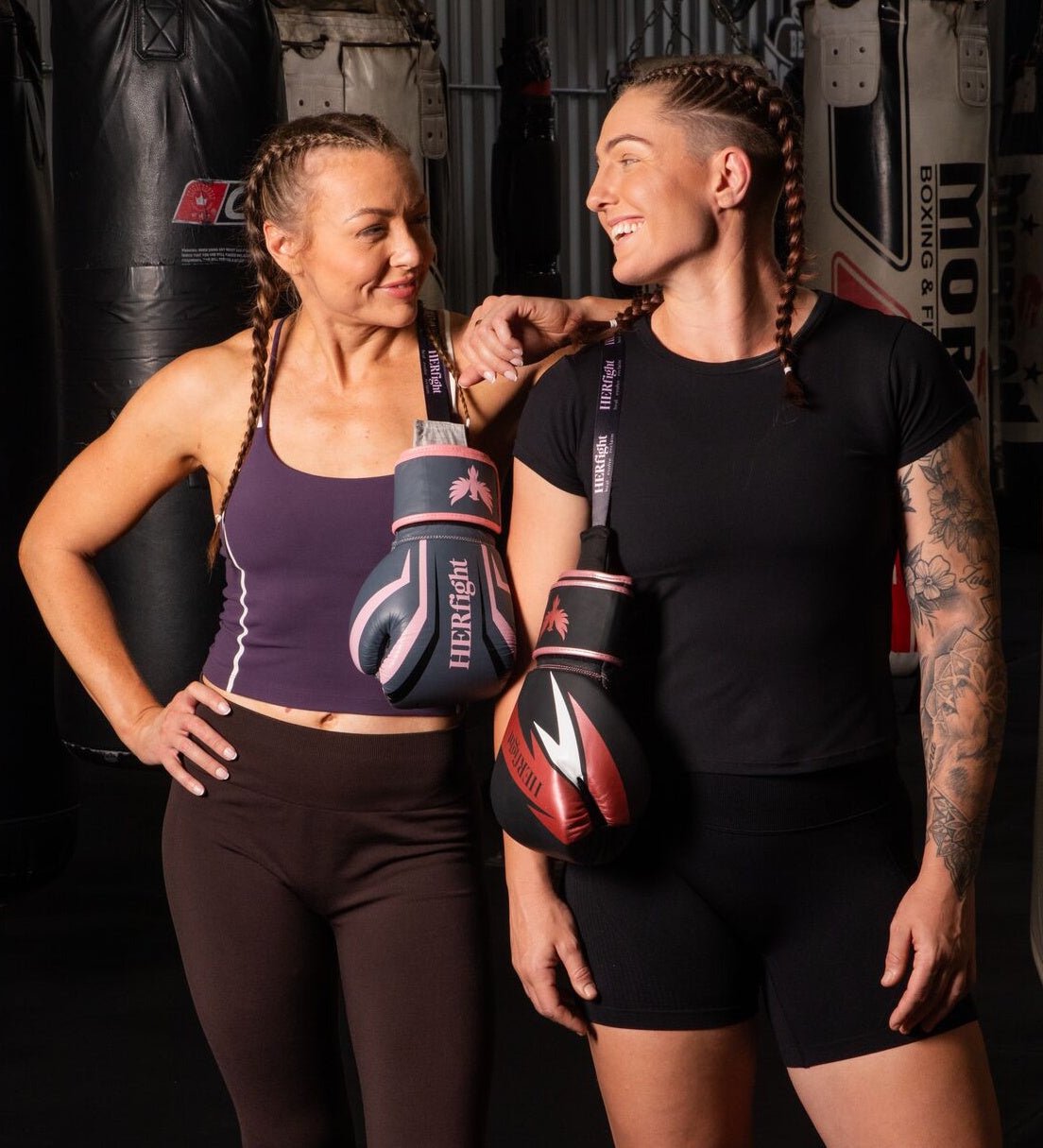 Women’s boxing gloves for women, two women in a gym holding gloves after training