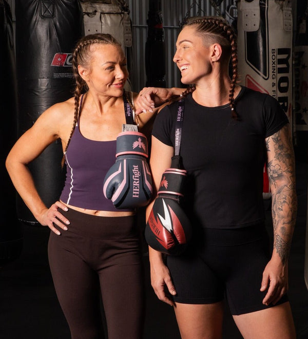 Women’s boxing gloves for women, two women in a gym holding gloves after training